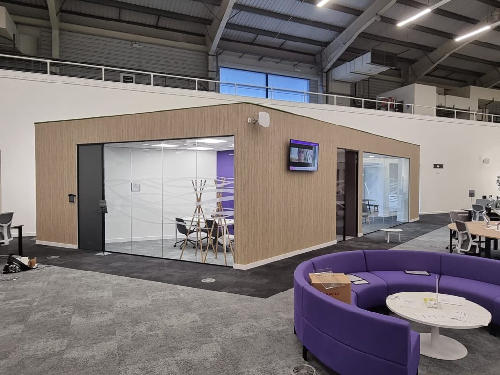 Meeting room walls boarded, jointed and clad on an open-plan floor