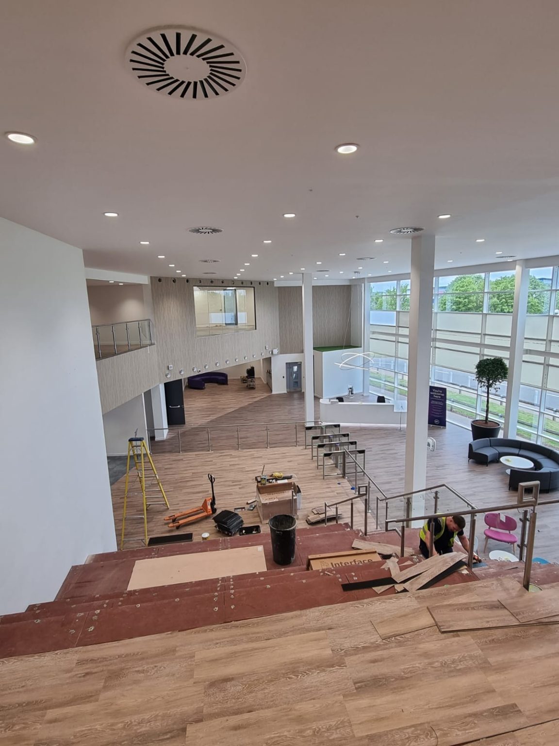 Reception and stair area with a finished ceiling and diffuser, handed over