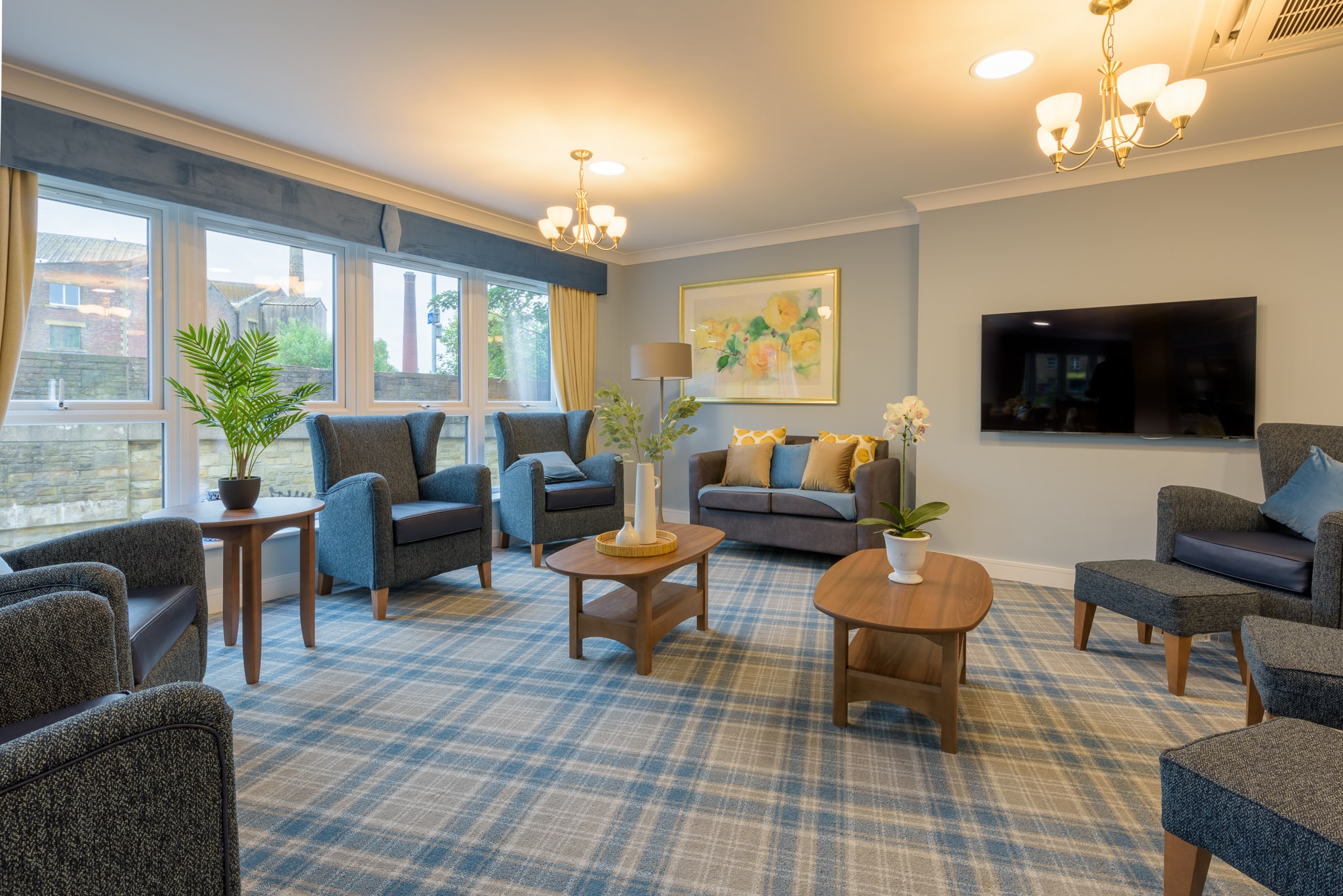 Communal lounge ceiling with recessed downlights and pendant lighting