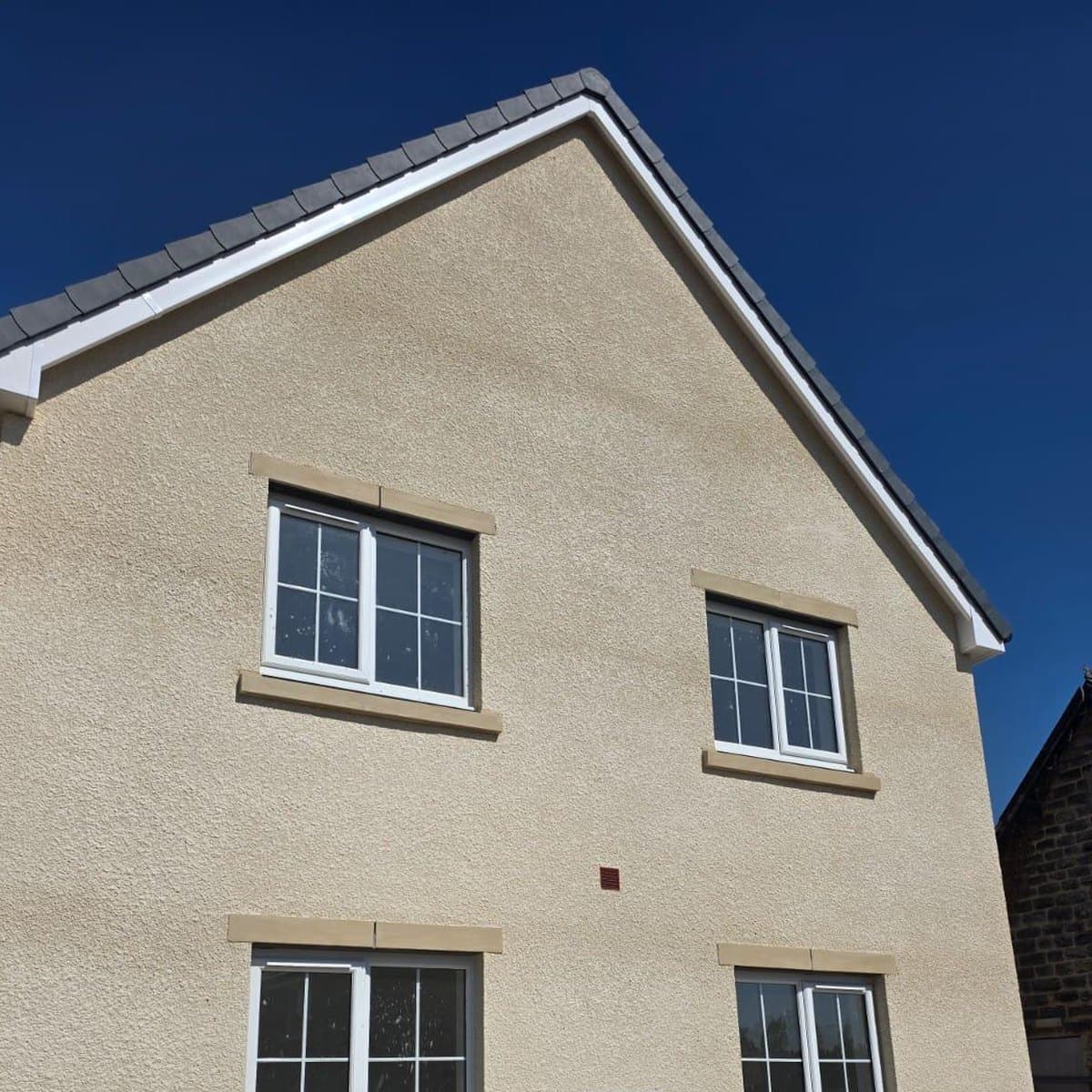 Completed new build house with a through-coloured render finish