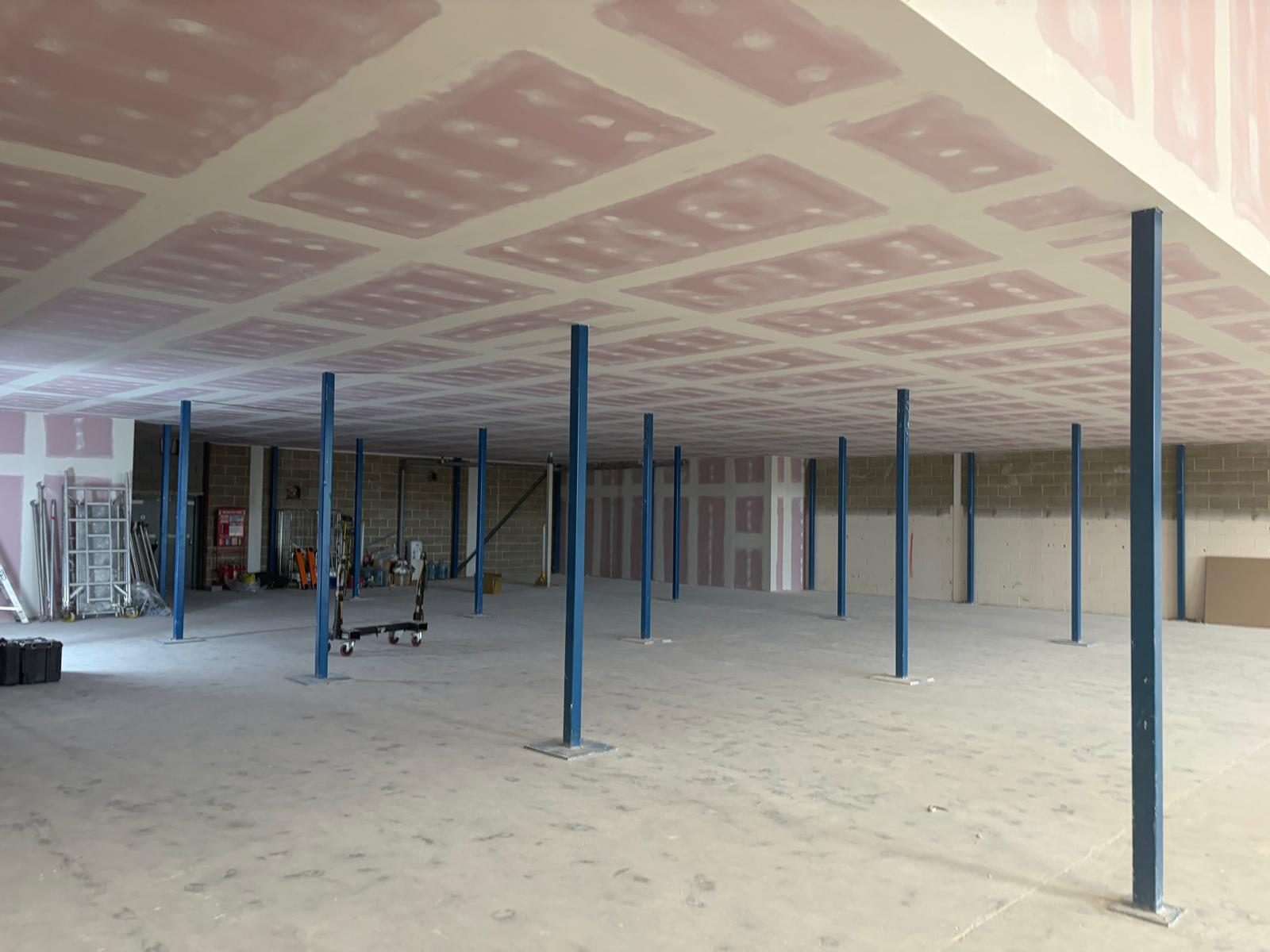 Fire-rated board fixed, taped and jointed to the underside of a mezzanine floor