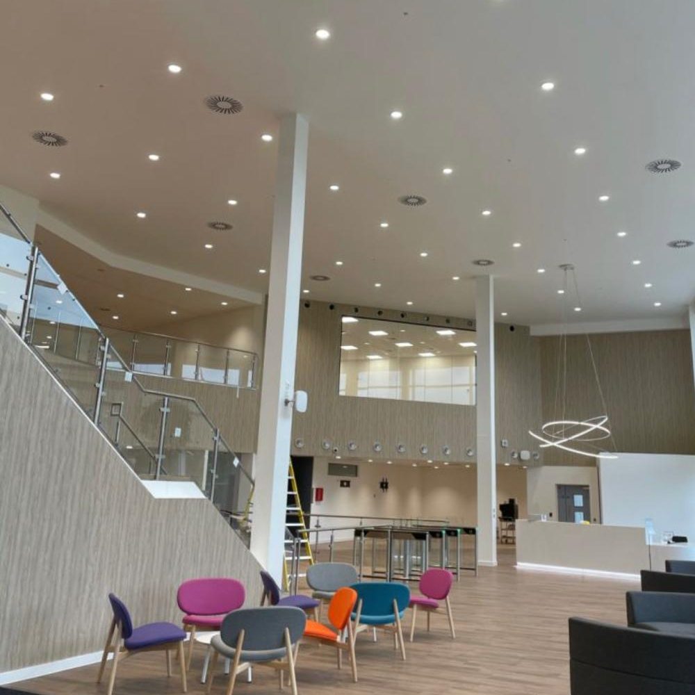 Finished plasterboard ceiling with downlights over a double-height reception