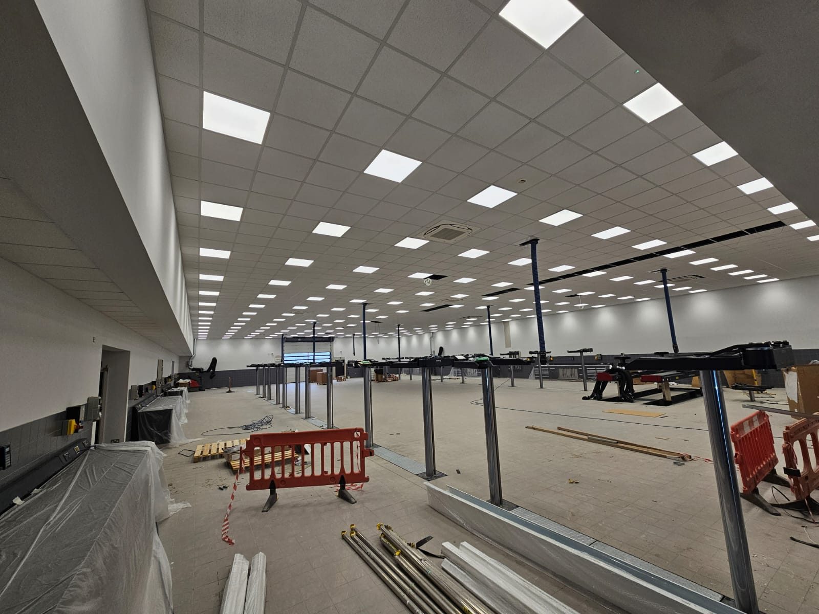 Suspended grid ceiling with LED panels over a retail unit during fit-out