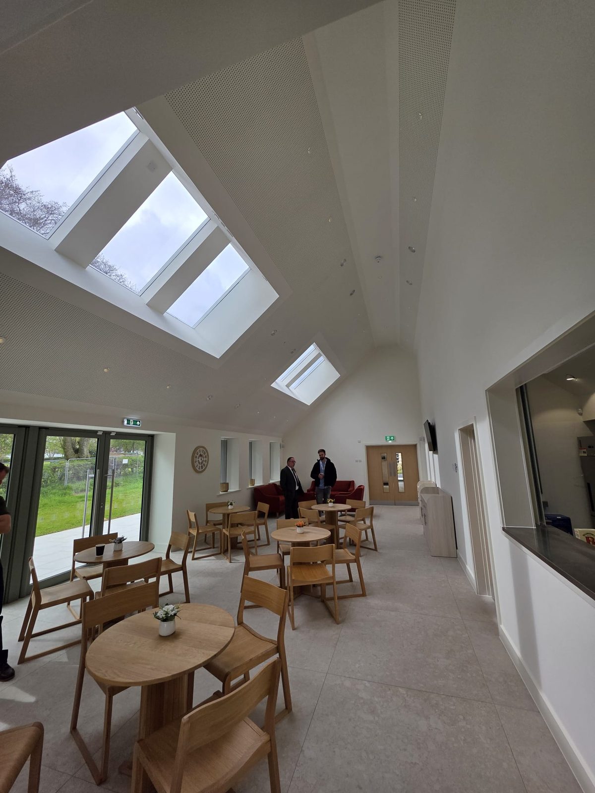 Finished cafe space under a vaulted ceiling with rooflights, ready for use