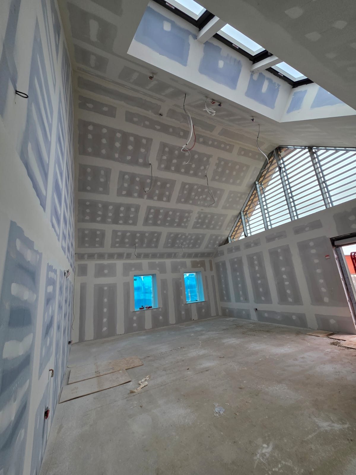 Vaulted room boarded, taped and jointed around its rooflights, before decoration