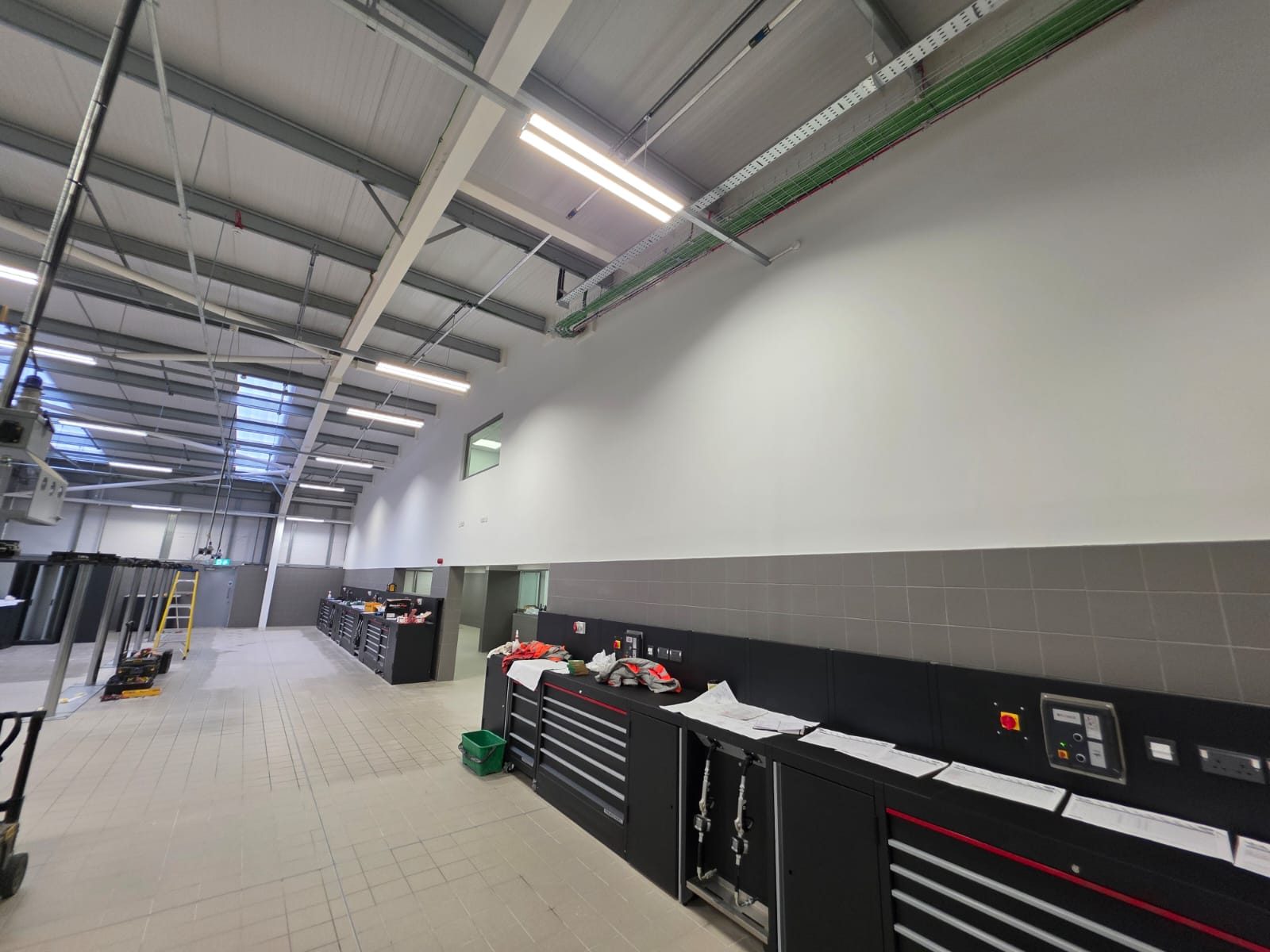 Workshop walls lined and finished to high level above tiled splashbacks and tool benches